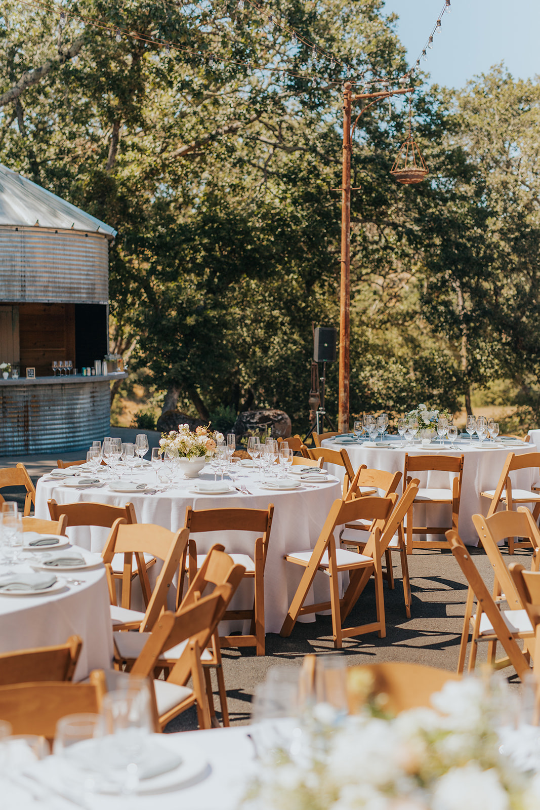 Set tables and the grain silo bar under string lights